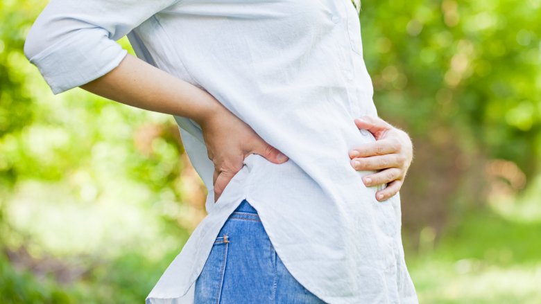 Pregnant woman early stages touching belly