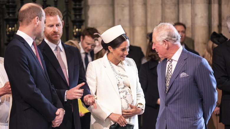 King Charles speaking with Meghan Markle