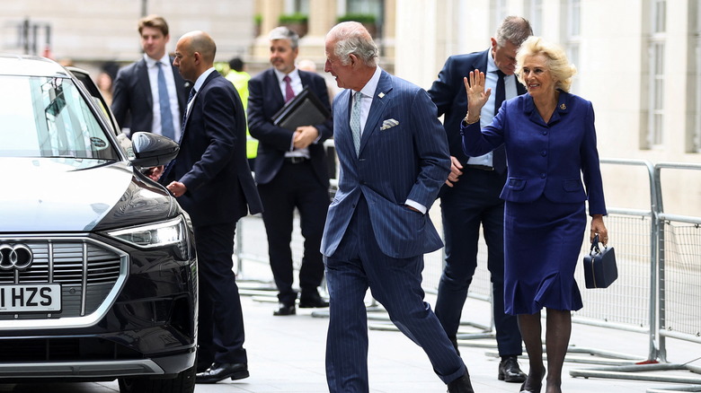 Prince Charles with staff in background 