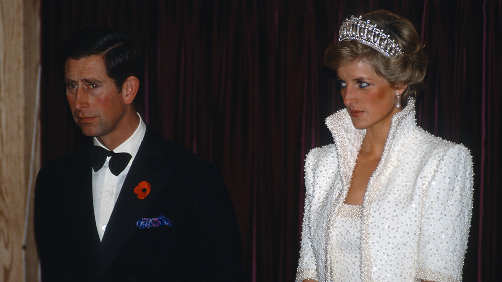 Prince Charles and Princess Diana, both looking serious