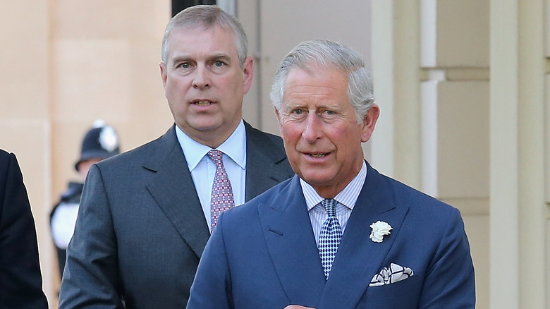 Prince Andrew and Prince Charles walking