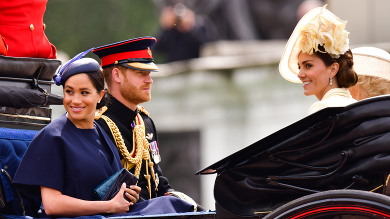 Meghan Markle, Prince Harry, and Kate Middleton in a carriage