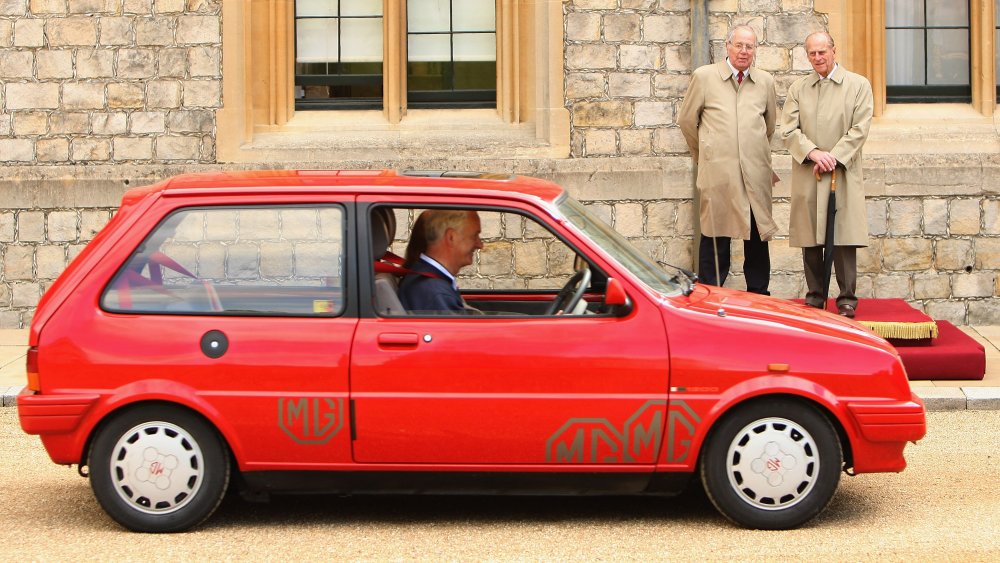 Prince Philip and an auto expert watching cars race in 2009