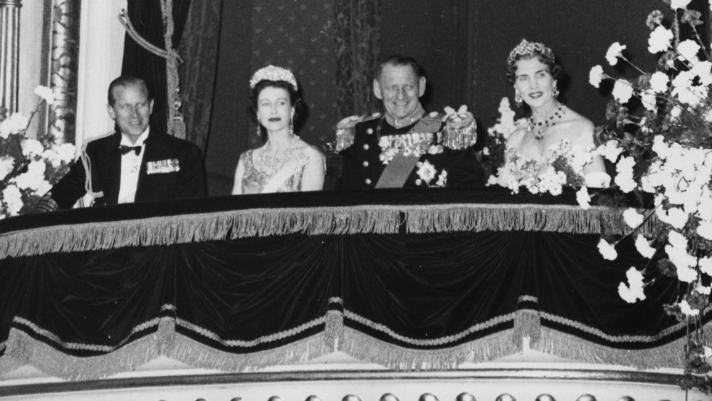 Prince Philip and Queen Elizabeth with guests at a performance in 1957