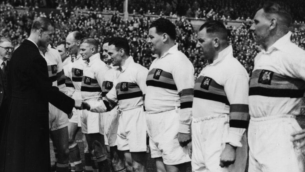 Prince Philip shaking hands with rugby players in 1949