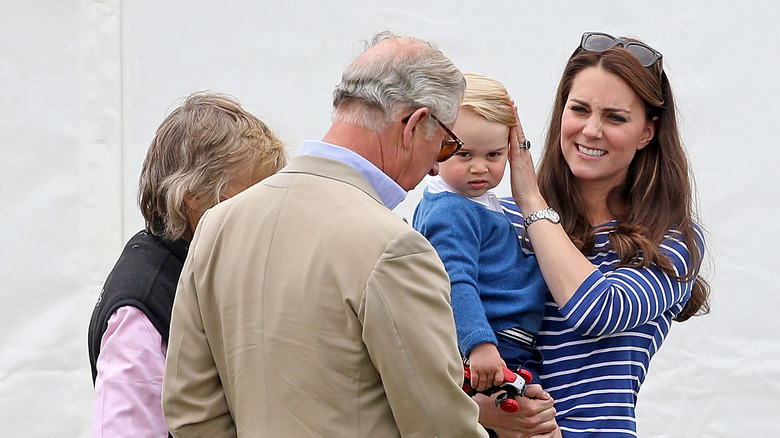 Prince Charles interacting with Prince George