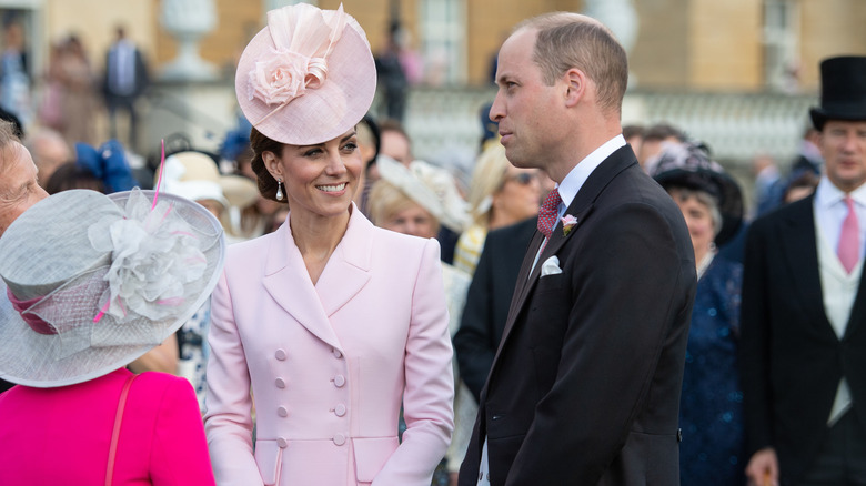 Princess Catherine smiling Prince William in conversation