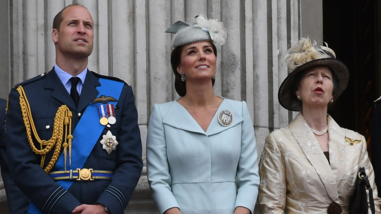 Prince William, Kate Middleton, and Princess Anne looking up