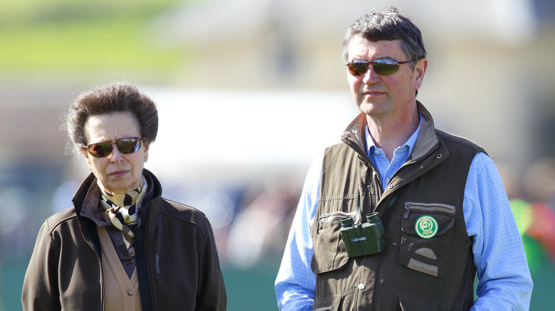 Princess Anne posing with Sir Timothy Laurence, both wearing sunglasses