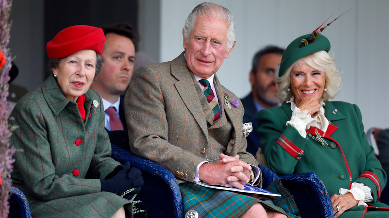 Princess Anne, King Charles, and Queen Camilla smiling 