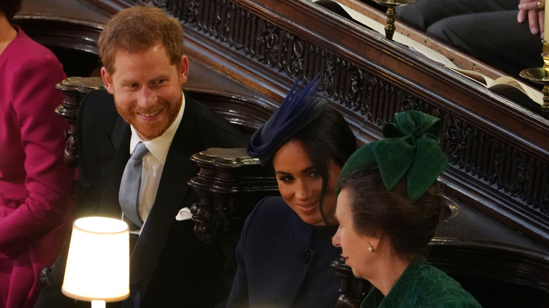 Prince Harry, Meghan Markle and Princess Anne at an event 