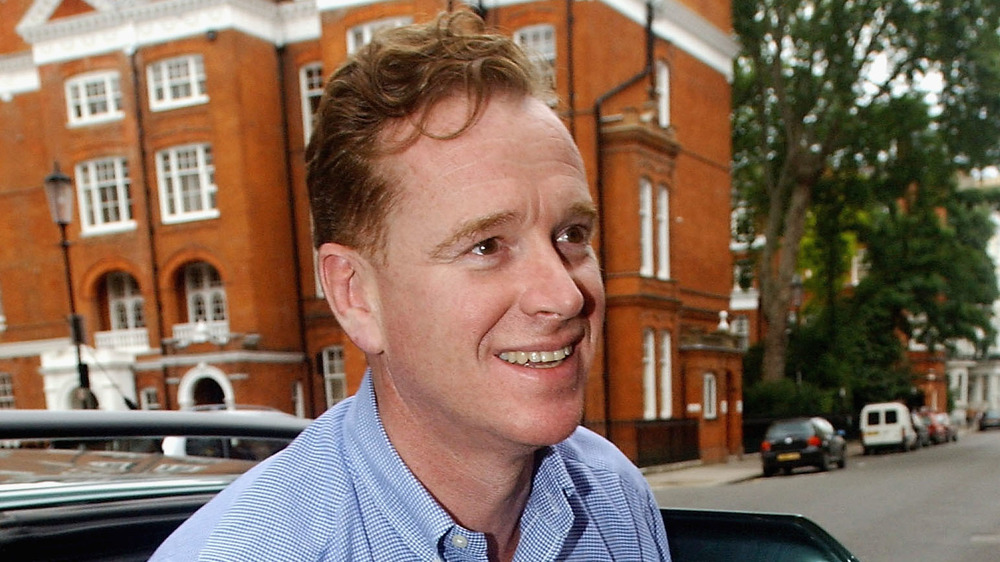 Major James Hewitt outside of a brick building