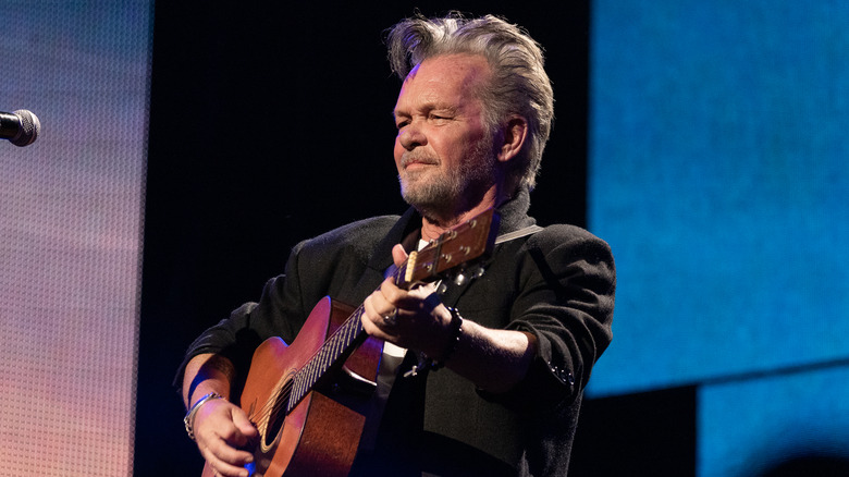 John Mellencamp performing on stage