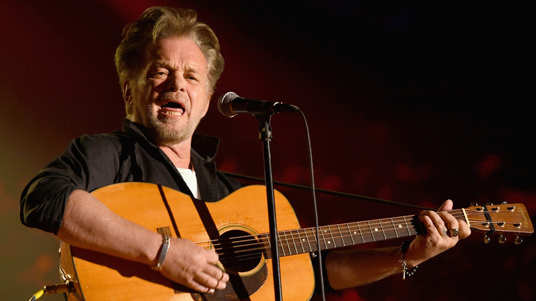 John Mellencamp performing on stage