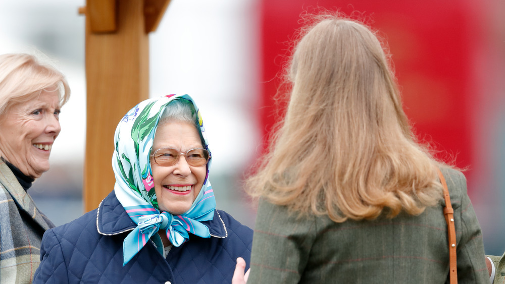 Queen Elizabeth smiling with scarf on her head