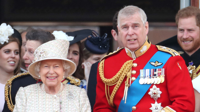 Prince Andrew standing by his mother's side