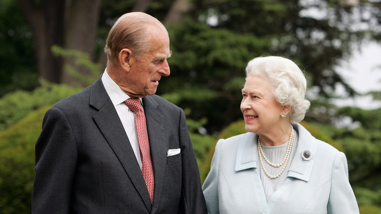 Prince Philip regards the queen in a garden