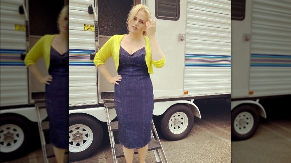 Rebel Wilson standing outside movie trailer