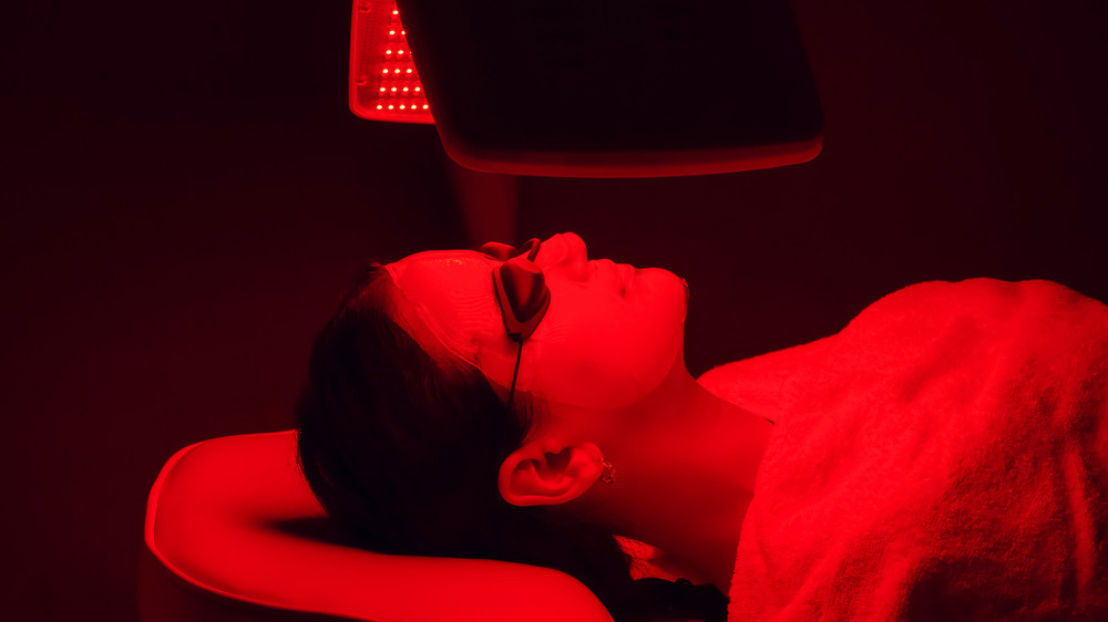 Woman under red light