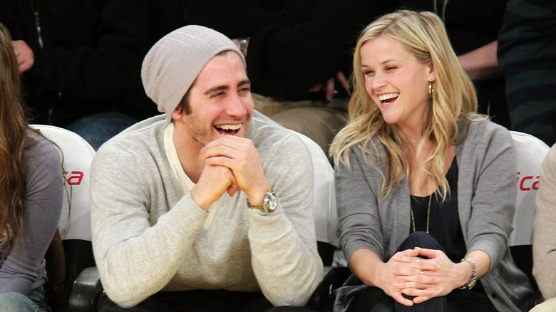 Reese Witherspoon and Jake Gyllenhaal laughing courtside