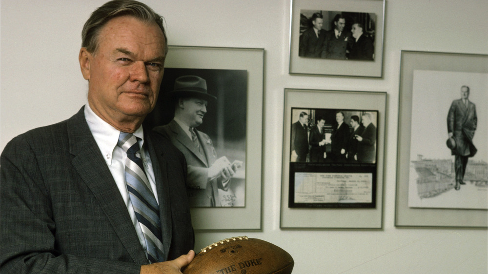 Wellington Mara holding a football 