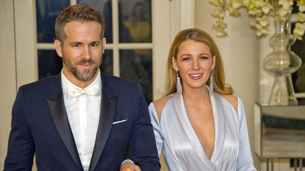 Ryan Reynolds and Blake Lively in front of a home