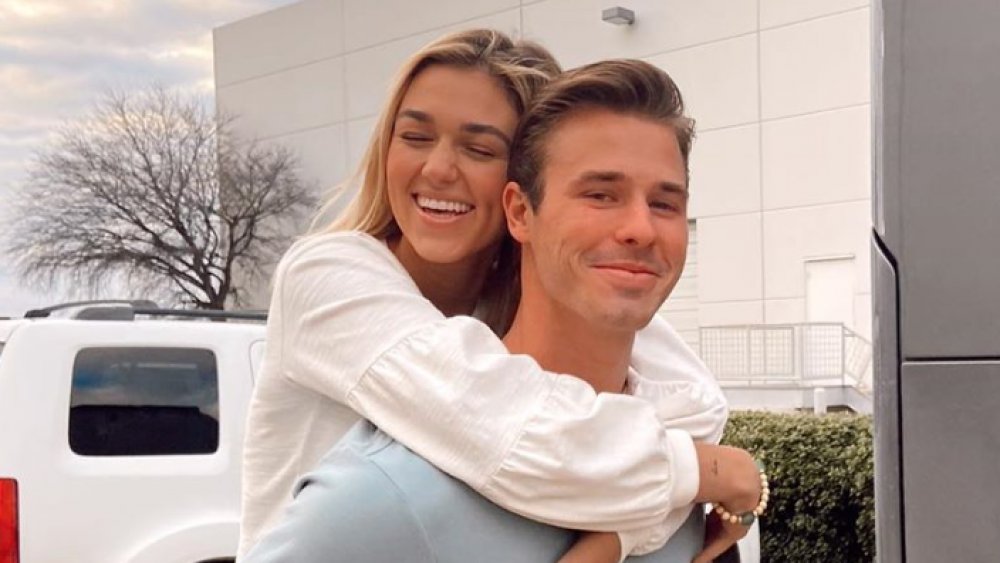 Christian Huff giving SadieRobertson a piggyback ride