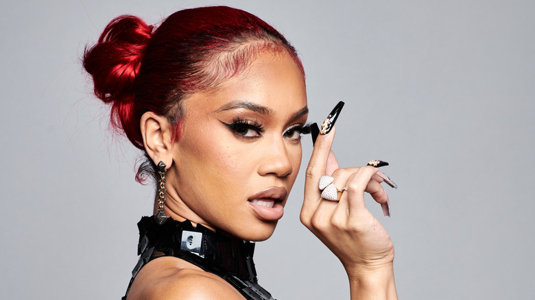 Saweetie with red hair and fake nails