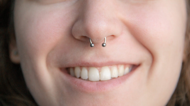A woman smiling with a pierced septum