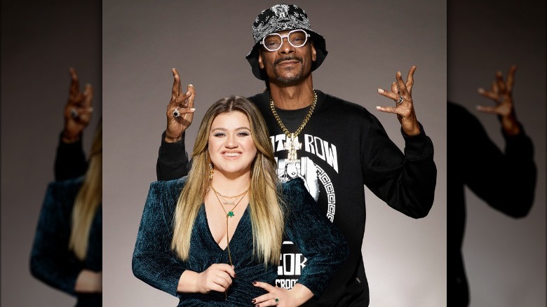American Song Contest's hosts Kelly Clarkson and Snoop Dogg standing next to each other