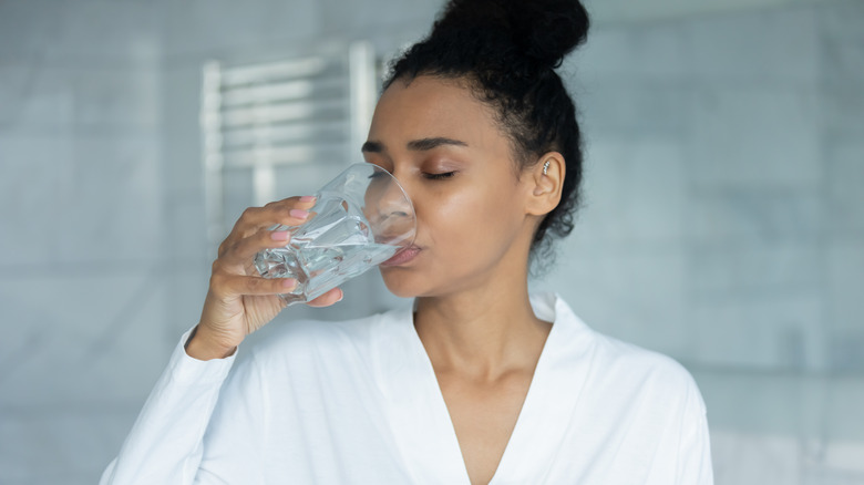 Dehydrated woman drinking water 