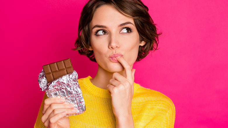 Woman eating chocolate bar