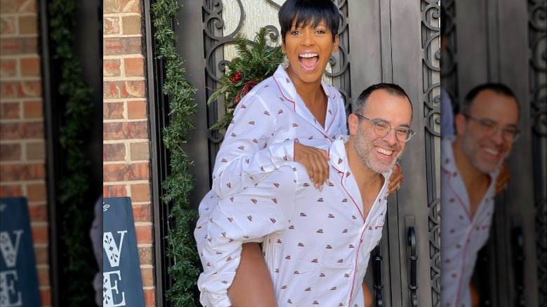 Steven Greener giving Tamron Hall a piggy back ride