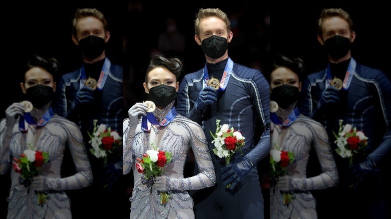 Madison Chock, Evan Bates displaying gold medals