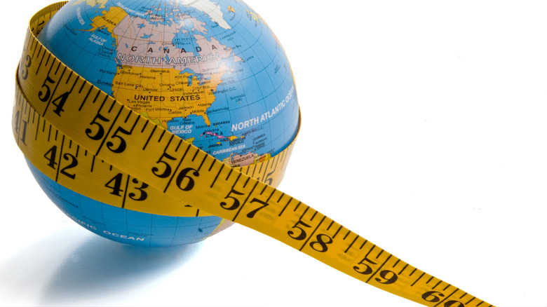 measuring tape around globe