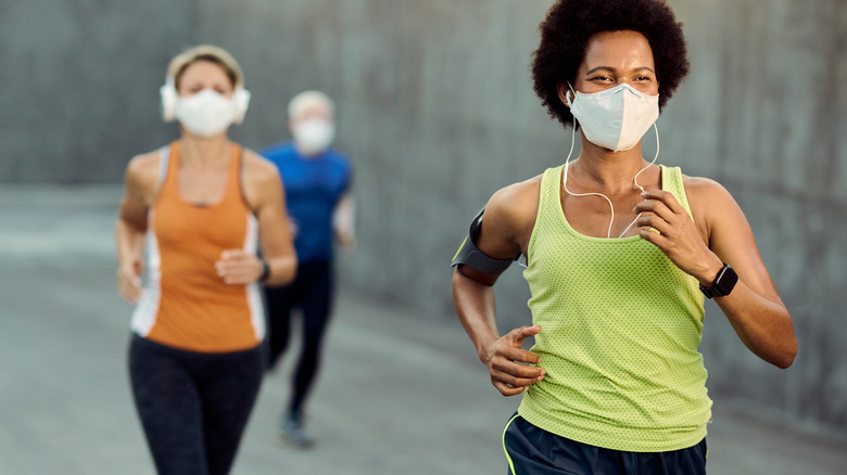 women running with face masks on