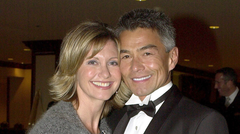 Olivia Newton-John and Patrick Kim McDermott posing