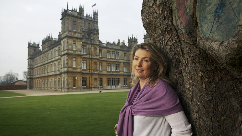 The Countess of Carnarvon leaning against tree