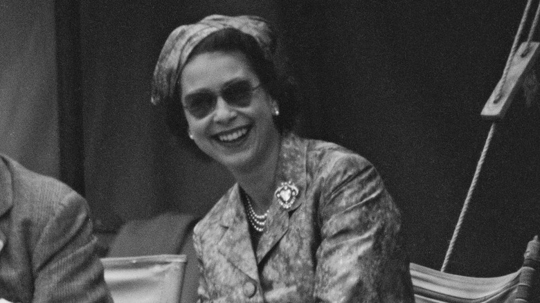 Queen Elizabeth II smiling, wearing sunglasses 