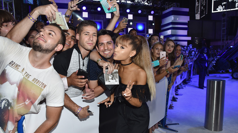 Ariana Grande posing with fans