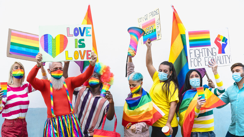 A group of protestors wearing pride gear