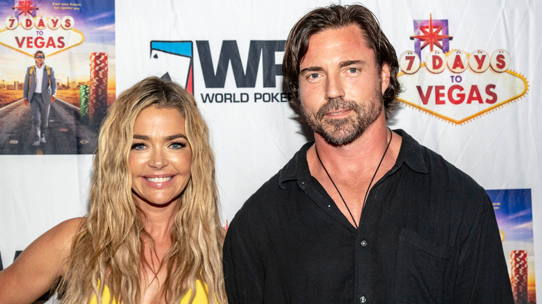 Denise Richards smiles beside husband Aaron Phypers