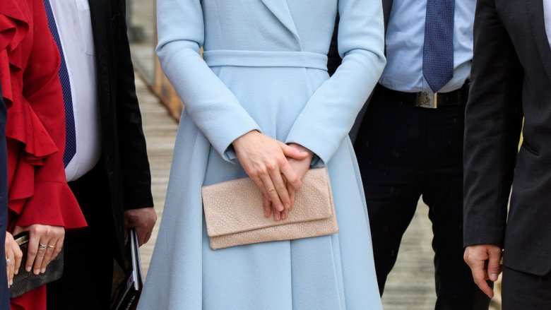 a royal holding a clutch