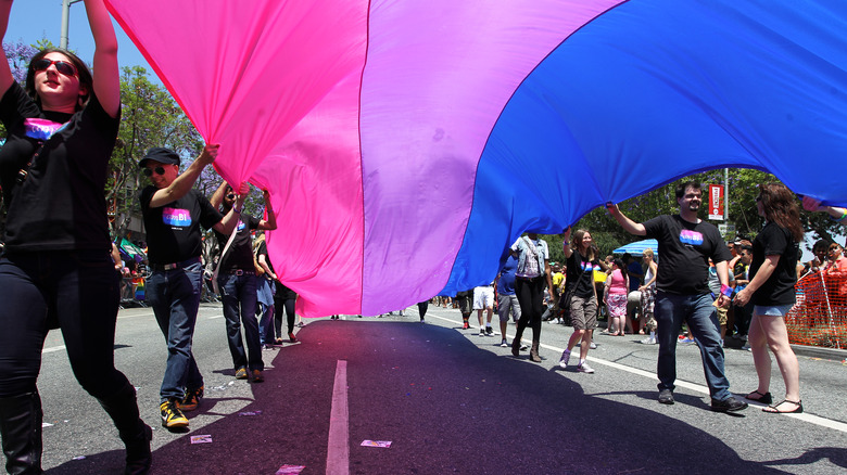 Pride marchers with a Bi Pride flag in 2019