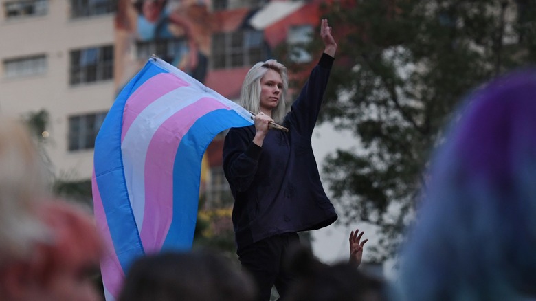 A protester with the trans flag