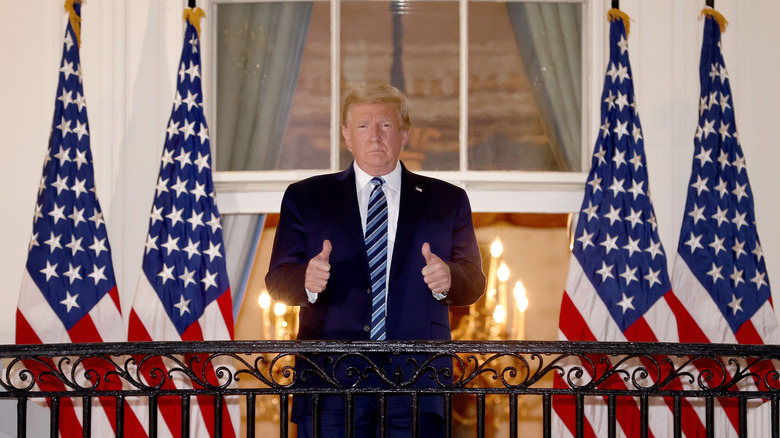 Donald Trump giving thumbs up on balcony at the White House