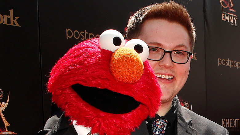 Ryan Dillon posing with Elmo puppet