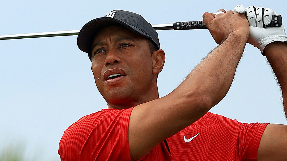 Tiger Woods holds a golf club