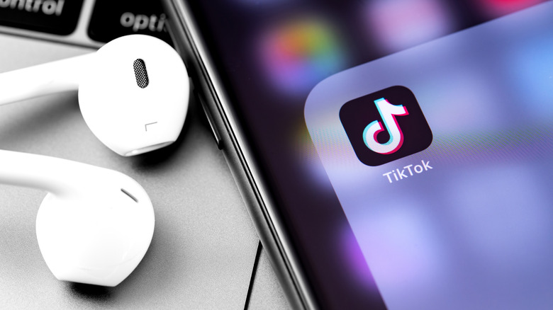 TikTok app open on phone with headphones 