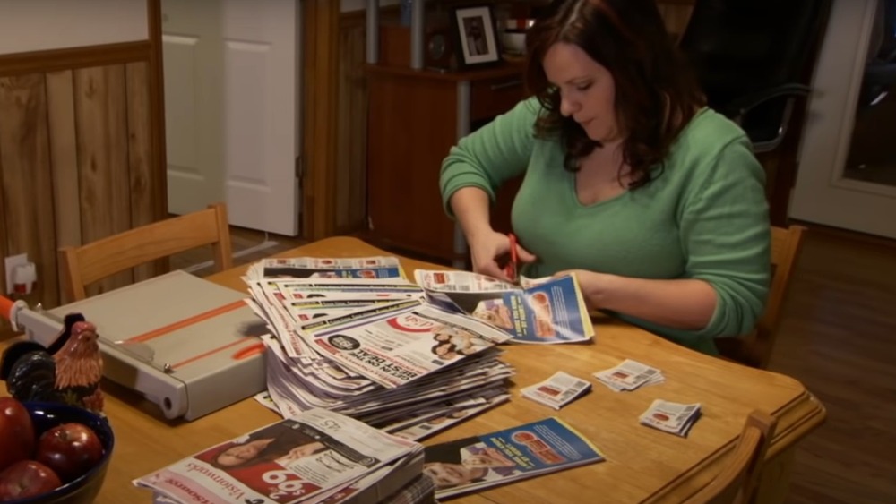 woman cutting coupons